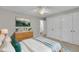 Bright bedroom featuring hardwood floors, a dresser with decor, and a large closet at 5804 Heatherbrook Cir, Raleigh, NC 27612