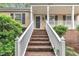 Close-up of the front staircase, featuring brick steps, white railings, and a cozy entryway at 5804 Heatherbrook Cir, Raleigh, NC 27612
