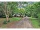 Charming single-Gathering home featuring a covered front porch, beautiful landscaping, and a long driveway at 5804 Heatherbrook Cir, Raleigh, NC 27612