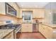 Traditional kitchen with granite countertops, stainless steel appliances, and hardwood flooring at 5804 Heatherbrook Cir, Raleigh, NC 27612