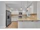 Well-equipped kitchen features stainless steel appliances, white cabinets, and bar seating at 5804 Heatherbrook Cir, Raleigh, NC 27612