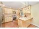 Well-lit kitchen featuring stainless steel appliances, granite countertops, and ample storage, complemented by an island at 5804 Heatherbrook Cir, Raleigh, NC 27612