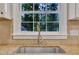 Kitchen sink featuring granite countertop and stainless steel faucet, with window view at 5804 Heatherbrook Cir, Raleigh, NC 27612