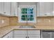 Kitchen view featuring a stainless steel sink, granite countertops, and white cabinets at 5804 Heatherbrook Cir, Raleigh, NC 27612