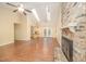 Bright open floor plan featuring a living room, wood floors, a fireplace and skylights, seamlessly connected to the kitchen at 5804 Heatherbrook Cir, Raleigh, NC 27612