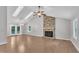 Bright living room features a brick fireplace, skylights and a ceiling fan at 5804 Heatherbrook Cir, Raleigh, NC 27612