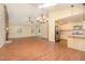 Spacious open floor plan featuring a living room, wood floors, a fireplace and skylights, seamlessly connected to the kitchen at 5804 Heatherbrook Cir, Raleigh, NC 27612
