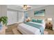 Serene main bedroom with modern decor, hardwood floors, a ceiling fan, and ample closet space at 5804 Heatherbrook Cir, Raleigh, NC 27612