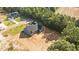 Aerial view of the gray house with a covered porch, set on a large lot with a wooded backdrop at 60 Stream View Way, Spring Hope, NC 27882