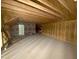 Spacious unfinished attic area with exposed wood beams and plywood walls, ready for customization at 60 Stream View Way, Spring Hope, NC 27882