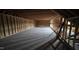 Unfinished attic space with exposed wooden framing, a window, and flooring at 60 Stream View Way, Spring Hope, NC 27882