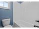 Bathroom showing a tub, toilet, and clean white tiles, offering a relaxing and modern space at 60 Stream View Way, Spring Hope, NC 27882