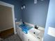 Bathroom with dual vanity, modern fixtures and striking patterned floor for a fresh, stylish look at 60 Stream View Way, Spring Hope, NC 27882