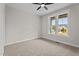 Bright bedroom with a ceiling fan, two windows, and neutral carpet providing a cozy space at 60 Stream View Way, Spring Hope, NC 27882