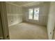 Bright unfinished bedroom features a window providing natural light, primed walls ready for paint at 60 Stream View Way, Spring Hope, NC 27882