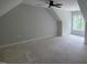 An upper floor bedroom with an angled ceiling, a ceiling fan, and large window at 60 Stream View Way, Spring Hope, NC 27882