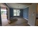 View of the dining area with stylish modern lighting and freshly painted blue accent walls at 60 Stream View Way, Spring Hope, NC 27882