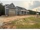 Beautiful single-Gathering home featuring blue siding, brick accents, and a charming front porch with columns at 60 Stream View Way, Spring Hope, NC 27882