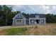 Inviting two-story home with a combination of blue siding and brick accents for a timeless exterior at 60 Stream View Way, Spring Hope, NC 27882