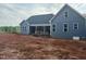 Exterior elevation of the home featuring blue siding, dark roof and unfinished landscaping at 60 Stream View Way, Spring Hope, NC 27882