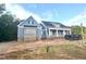 Charming new two-story home with blue siding, covered porch and black accents in a wooded setting at 60 Stream View Way, Spring Hope, NC 27882