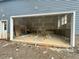 Unfinished two-car garage with white trim, blue siding, and natural light from the window at 60 Stream View Way, Spring Hope, NC 27882