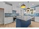 Modern kitchen with white cabinets, navy island, stainless steel appliances, and subway tile backsplash at 60 Stream View Way, Spring Hope, NC 27882