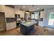 Stylish kitchen featuring white cabinetry, a dark island, and modern appliances at 60 Stream View Way, Spring Hope, NC 27882