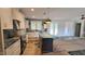 Bright and airy kitchen featuring white cabinetry, island with granite countertops, and a large farmhouse sink at 60 Stream View Way, Spring Hope, NC 27882