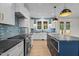 Beautiful kitchen showcasing white cabinetry, a contrasting dark island, and stainless steel appliances at 60 Stream View Way, Spring Hope, NC 27882