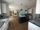 Open concept kitchen featuring a large island, modern appliances, and direct view of the living room fireplace at 60 Stream View Way, Spring Hope, NC 27882