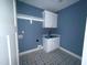 Well-lit laundry room, with stylish tile flooring, offers both functionality and aesthetic appeal at 60 Stream View Way, Spring Hope, NC 27882