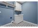 Laundry room with patterned tile flooring, a sink, and a storage cabinet at 60 Stream View Way, Spring Hope, NC 27882