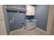 Laundry room features white cabinets, a sink, and patterned floor tiles at 60 Stream View Way, Spring Hope, NC 27882