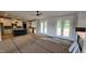 Open floor plan with a view of the kitchen and access to a porch with double doors at 60 Stream View Way, Spring Hope, NC 27882