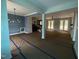 Spacious living room featuring open floor plan, abundant natural light and contemporary light fixture at 60 Stream View Way, Spring Hope, NC 27882
