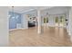 Bright open-concept living room with wood floors, modern light fixtures, and seamless access to kitchen at 60 Stream View Way, Spring Hope, NC 27882