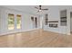 Bright living room featuring a fireplace, modern ceiling fan, and French doors to the outdoor area at 60 Stream View Way, Spring Hope, NC 27882