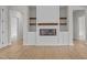 Living room boasts a modern fireplace with shelving and white cabinets at 60 Stream View Way, Spring Hope, NC 27882