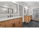 Modern main bathroom features double vanities and black hexagonal tile flooring at 60 Stream View Way, Spring Hope, NC 27882
