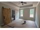Bedroom features a tray ceiling, natural light, and ensuite bathroom with sliding barn door at 60 Stream View Way, Spring Hope, NC 27882