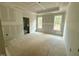 Bright main bedroom with two large windows and a tray ceiling at 60 Stream View Way, Spring Hope, NC 27882