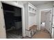 Mudroom with storage shelving and a built-in bench seat. Laundry area visible at 60 Stream View Way, Spring Hope, NC 27882