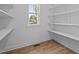 Pantry with white shelving and a view through a window, creating an organized space at 60 Stream View Way, Spring Hope, NC 27882
