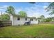Well-maintained backyard with a lush lawn, partial fence, and the home's exterior with multiple windows at 601 Longfellow St, Fuquay Varina, NC 27526