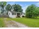 Well-kept single-story home with a front porch, surrounded by a lush, green lawn at 601 Longfellow St, Fuquay Varina, NC 27526