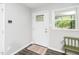 Bright foyer with a decorative front door and modern flooring and wall colors at 601 Longfellow St, Fuquay Varina, NC 27526