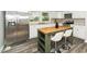 Modern kitchen with stainless steel appliances, white cabinets, and an island with seating at 601 Longfellow St, Fuquay Varina, NC 27526