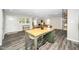 Open concept living room featuring an island, dining area, and abundant natural light at 601 Longfellow St, Fuquay Varina, NC 27526