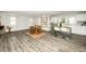 Open-concept living area featuring modern floors, a dining set, and a kitchen at 601 Longfellow St, Fuquay Varina, NC 27526